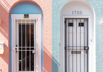 two white wooden doors with grills