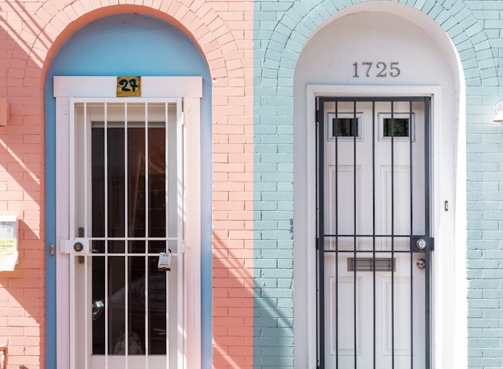 two white wooden doors with grills