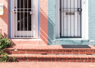 two white wooden doors with grills