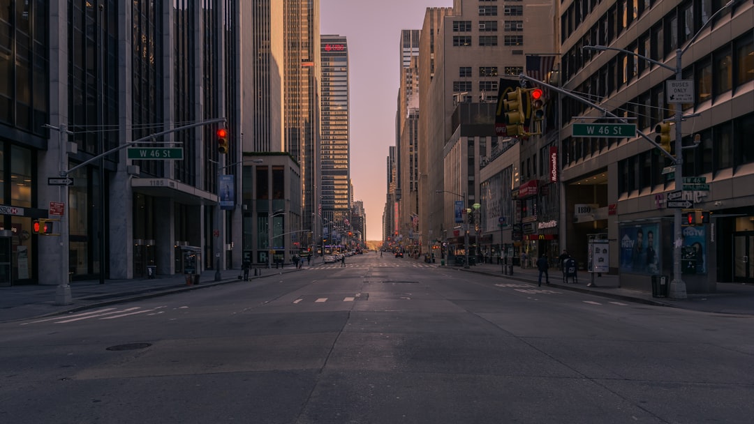 gray concrete road between buildings, 5th Ave. in New York at 7 o