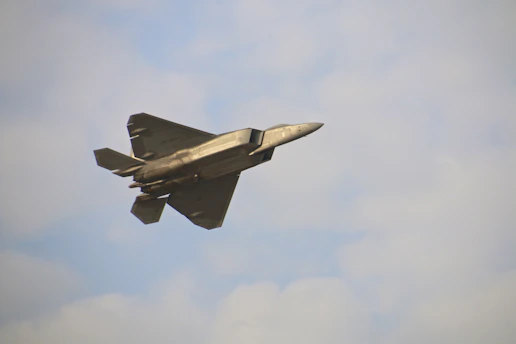 A military aircraft flying in the sky.