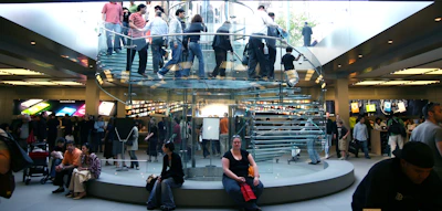 A bustling retail store with customers engaging enthusiastically with displayed products.