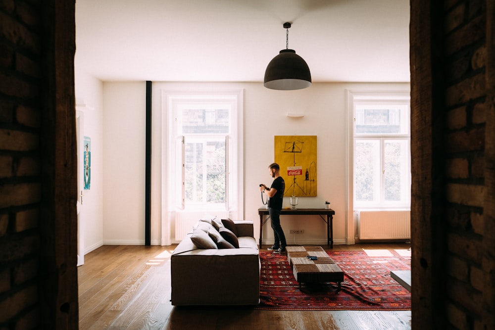 person standing near hallway table and window