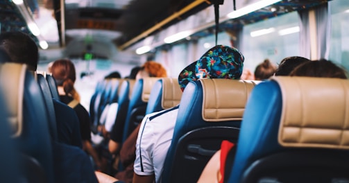 selective focus photography of people on bus