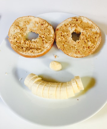 A playful peanut butter character made of food with googly eyes on a plate.