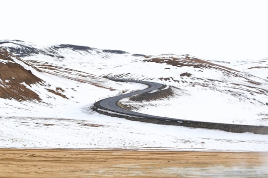 road in the middle of two mountains in Mývatn Iceland