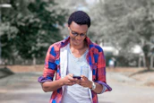 Smiling user checking side hustle options on a smartphone outdoors.