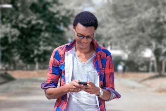 A friendly person using a smartphone outdoors, checking local cost and wait time data.