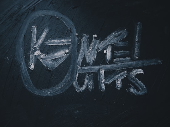 A dark surface with chalk writing that reads 'KNOWLEDGE LIMITS' in white, with the word 'KNOW' encircled.