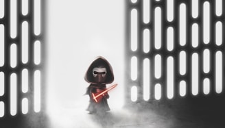 A figure resembling a Lego character stands in a space with glowing vertical lines on both sides. The character wears a dark cloak and hood, holding a bright red lightsaber. The background is filled with mist, creating a mysterious and dramatic atmosphere.