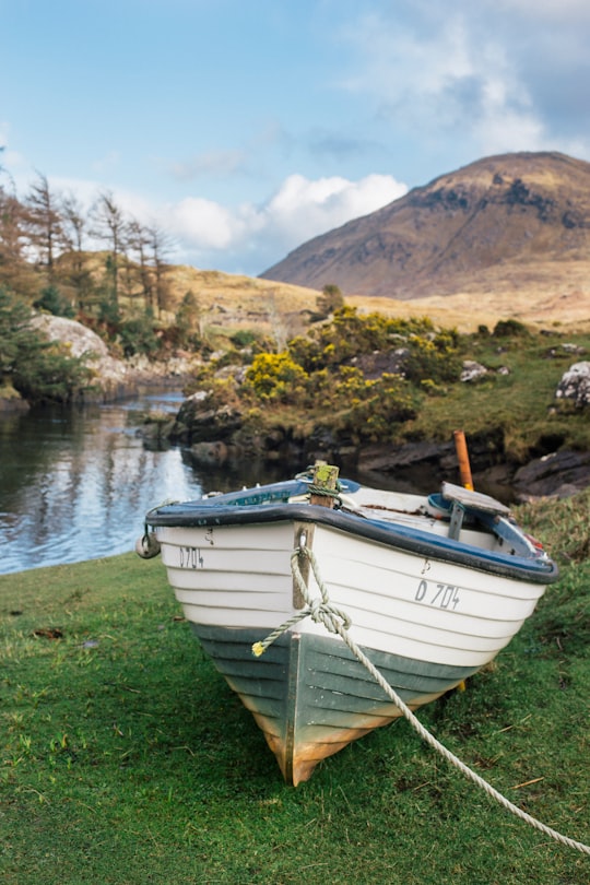 white boat near bodies of water in Connemara National Park Ireland