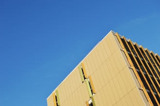 A striking exterior of a building with sharp geometric lines against a clear sky.