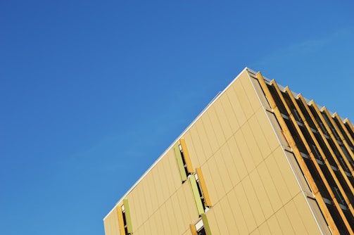 A striking exterior of a building with sharp geometric lines against a clear sky.