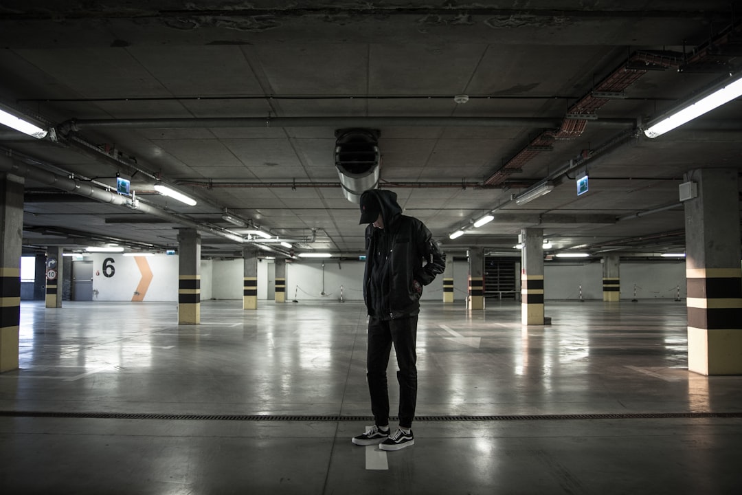 man standing in parking lot,