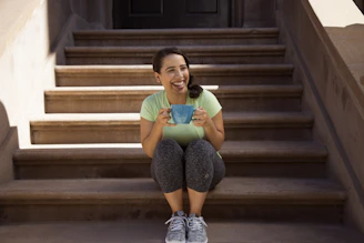 Photo of a happy customer holding a freshly printed mug and smiling outdoors.