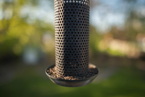 Close-up of durable plastic feeders with metal grids reducing feed waste.