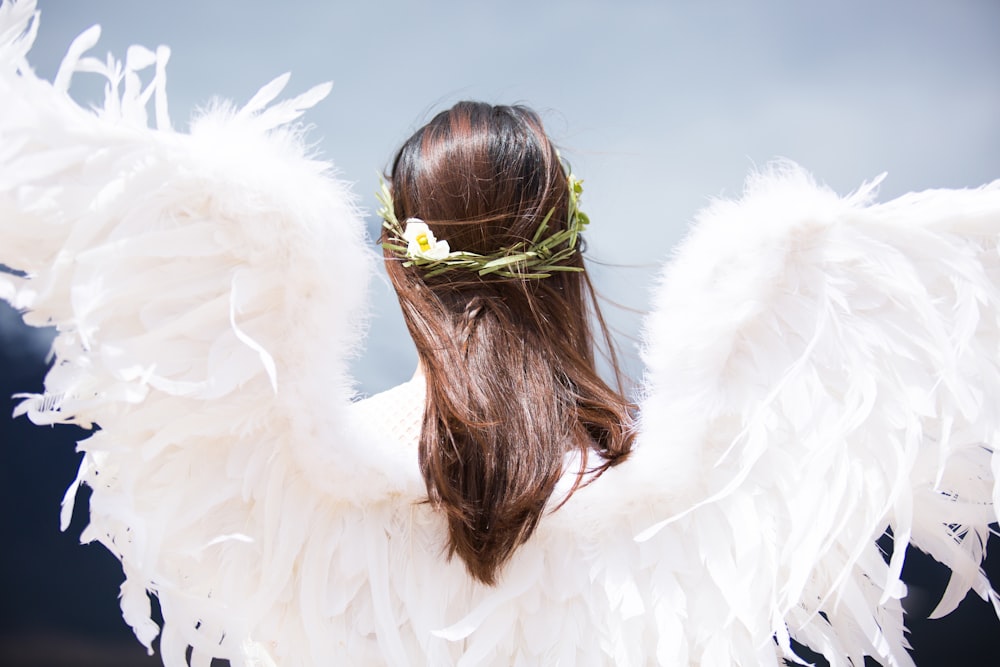 woman wearing white angel wings