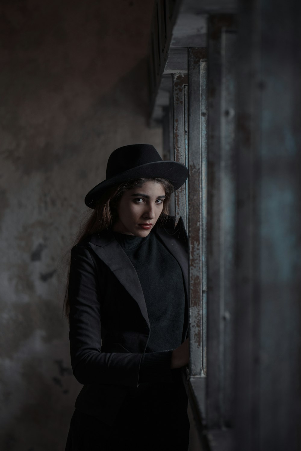 woman standing beside steel fence