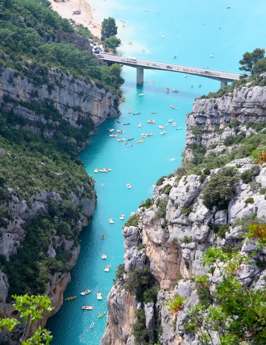 aerial view of boats on body of water beside mountain in Verdon Natural Regional Park France