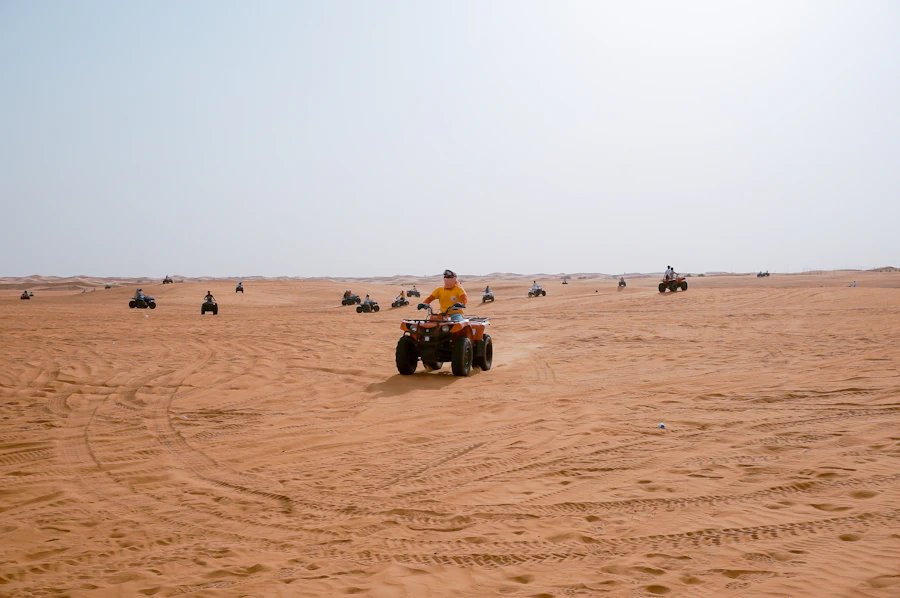 Several riders on quad bikes in the desert