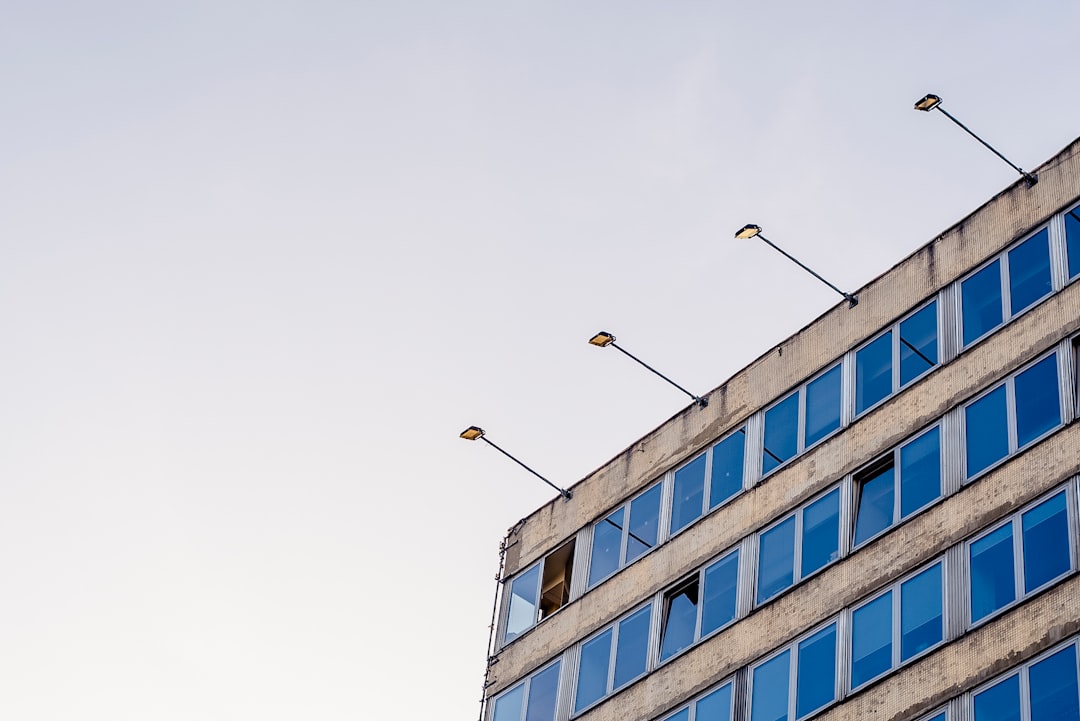 gray concrete building with blue glass window