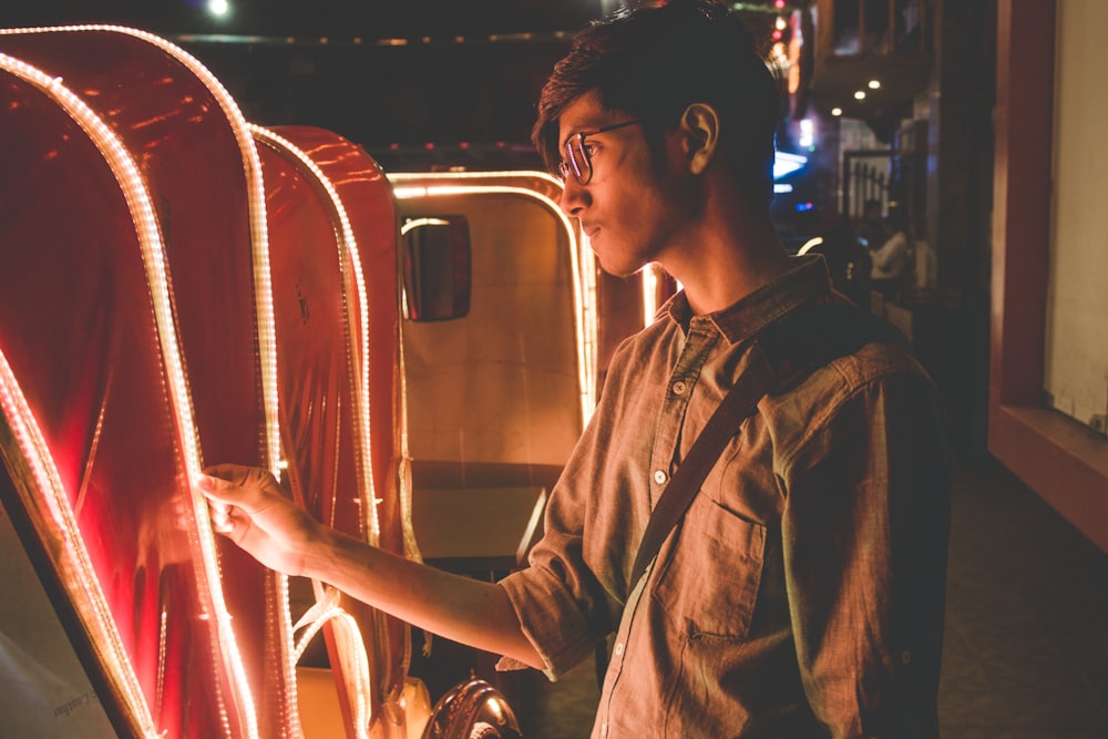 man wearing gray shirt holding cart