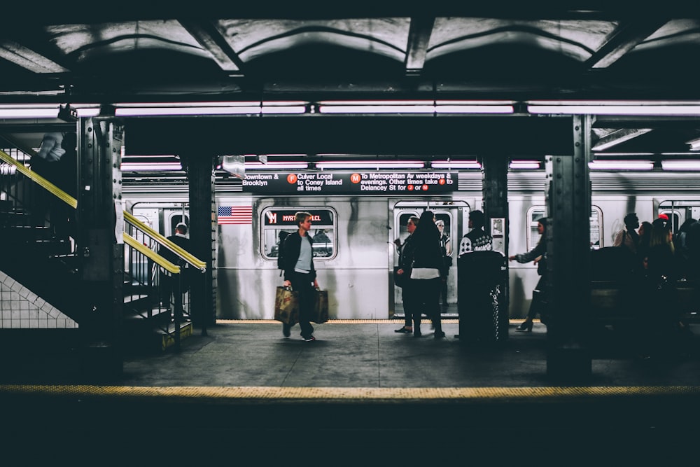 people standing near train