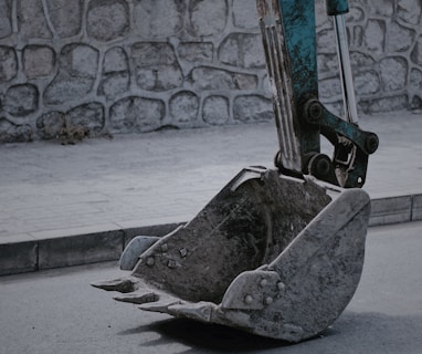 closeup photo of excavator bucket on road