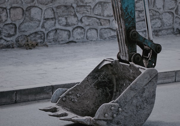 closeup photo of excavator bucket on road