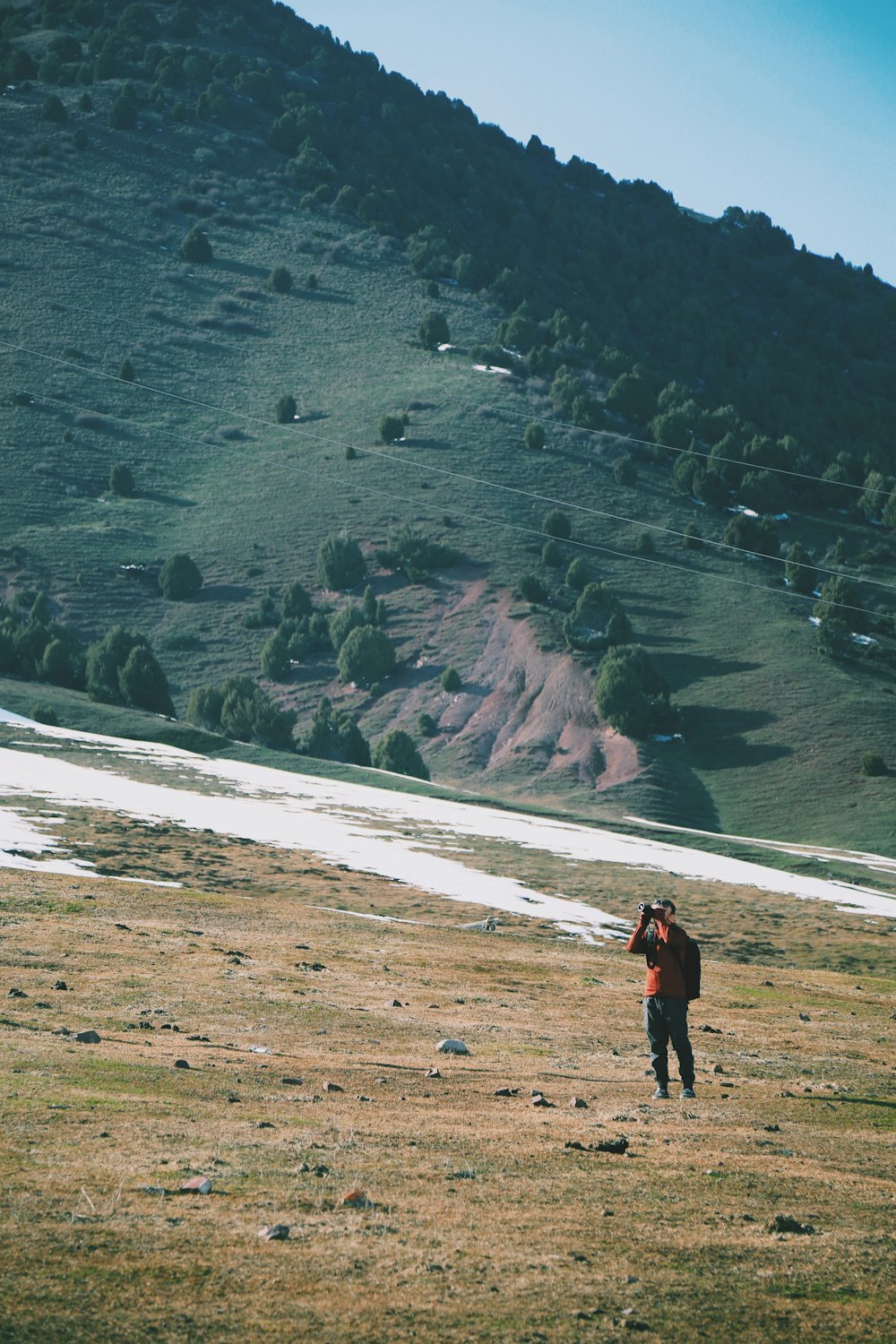 man wearing orange shirt hiking