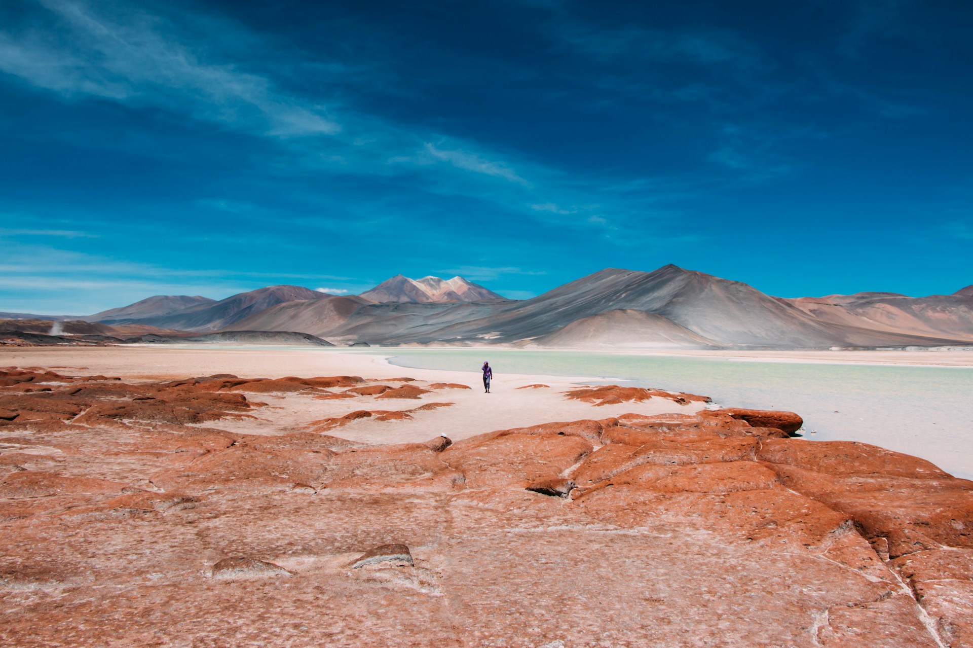 person walking in distance of mountain