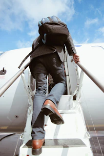 A business professional boarding an international flight, suitcase in hand, ready for new opportunities.