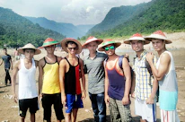 A group of friends wearing different brimora bucket hats, laughing outdoors on a sunny day.
