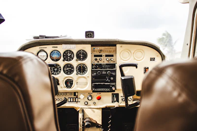 Close-up of a pilot reviewing flight plans inside a luxurious cockpit with polished instruments.