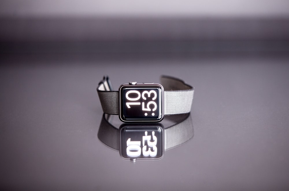 silver titanium Apple Watch with gray nylon strap