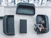 A customer checking their repair status on a smartphone while sitting in the waiting area.