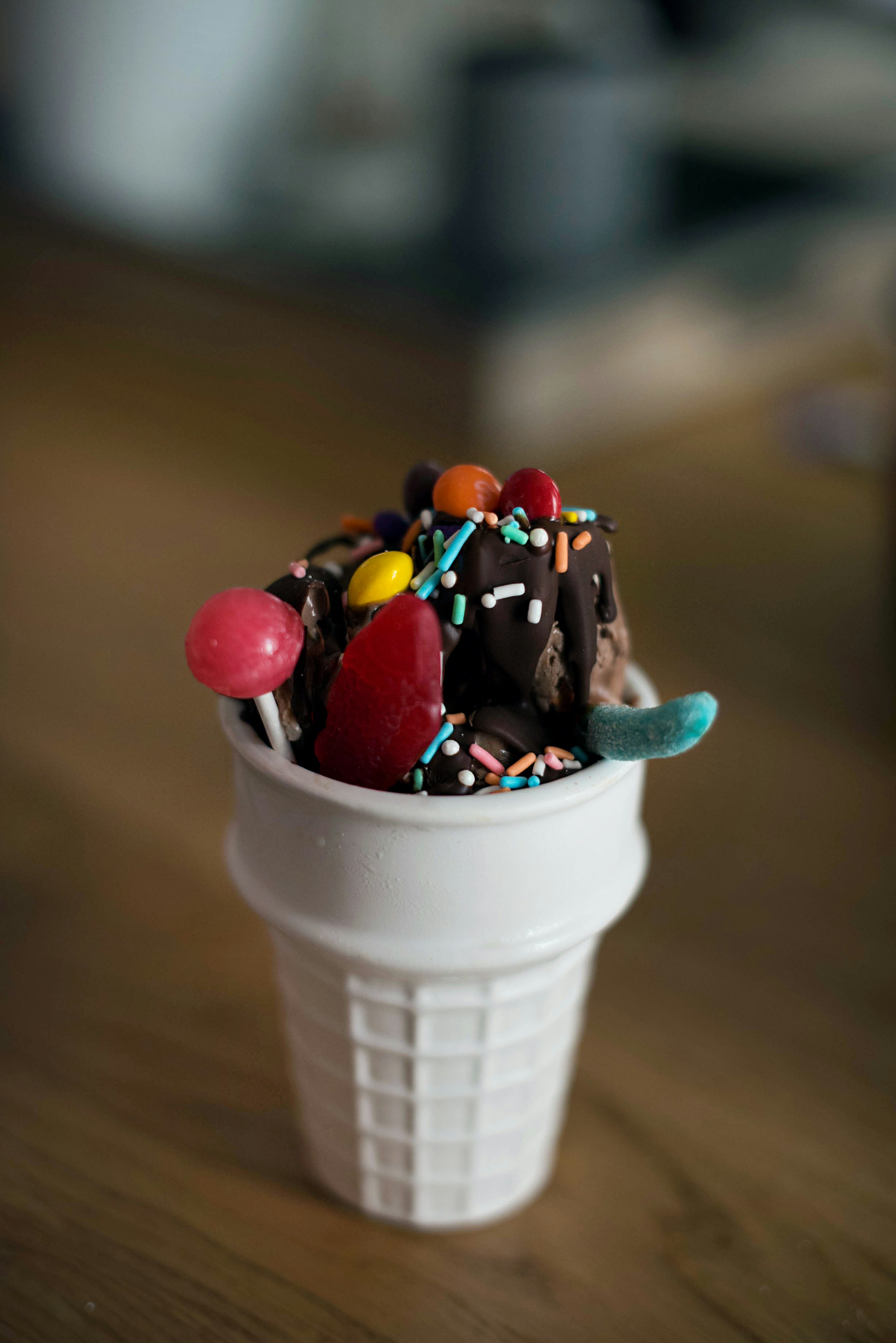 ice cream with sprinkles on white cup