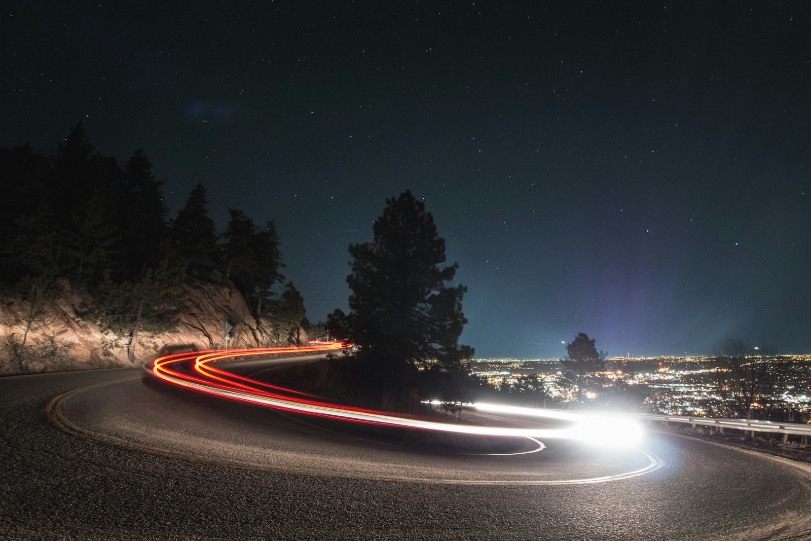 Timelapse photography on curved road beside tree
