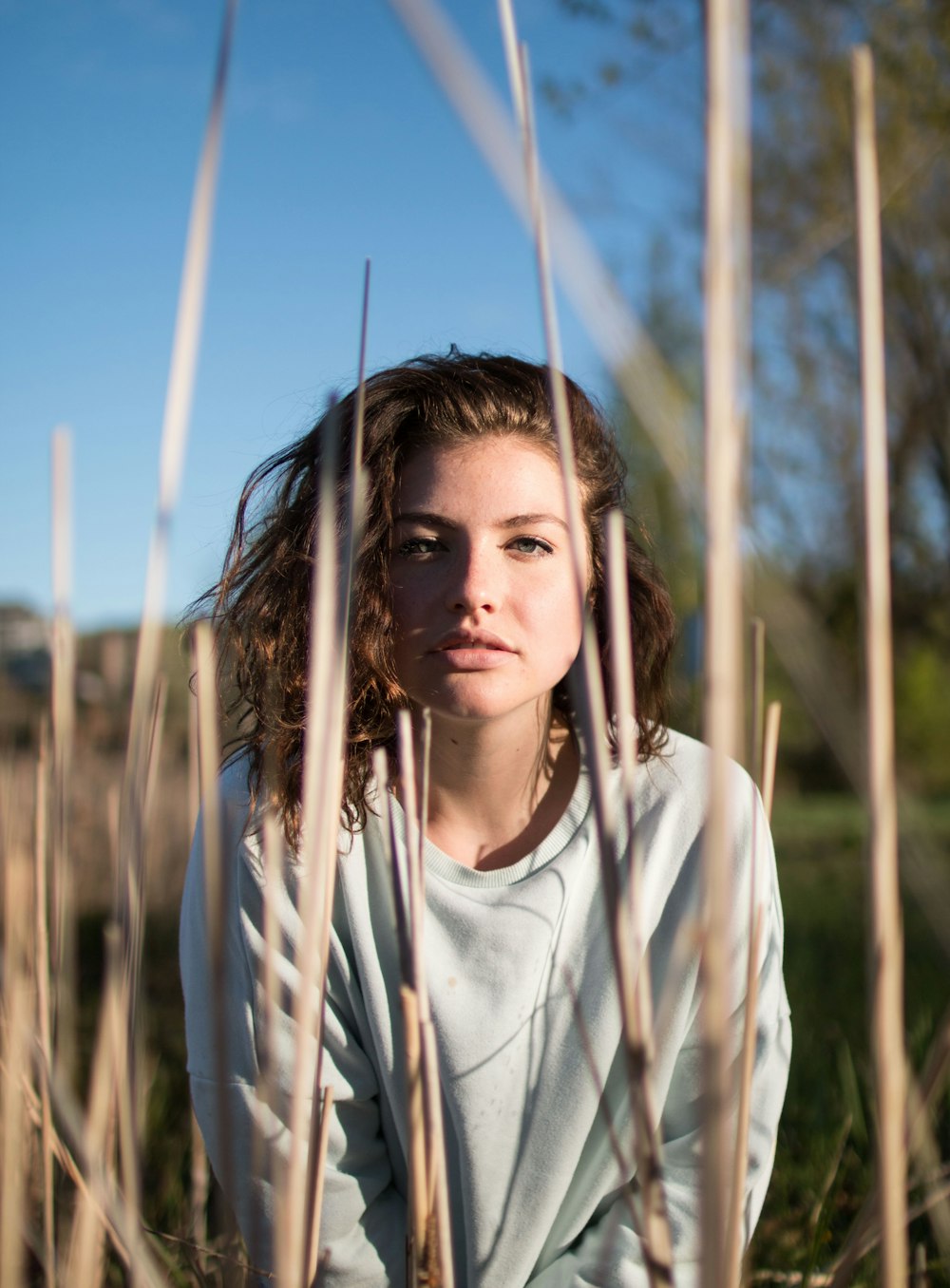 shallow focus photo of woman in gray crew-neck long-sleeved shirt