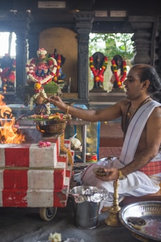 A serene pandit performing a traditional Vedic puja with sacred fire and offerings.