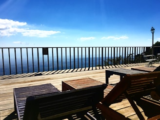 A modern deck with stylish outdoor furniture and a scenic view.