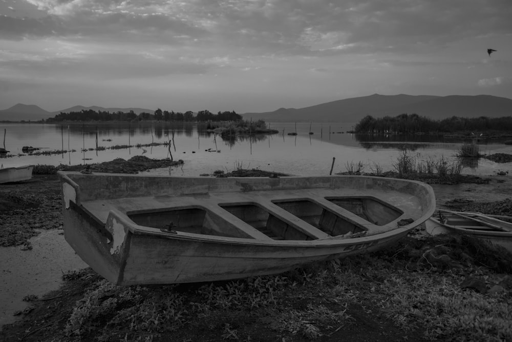 grayscale photo of boat on lake