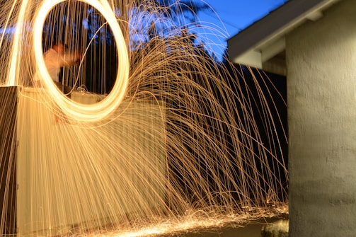 Dynamic candid photo from a lively outdoor wedding ceremony at twilight.
