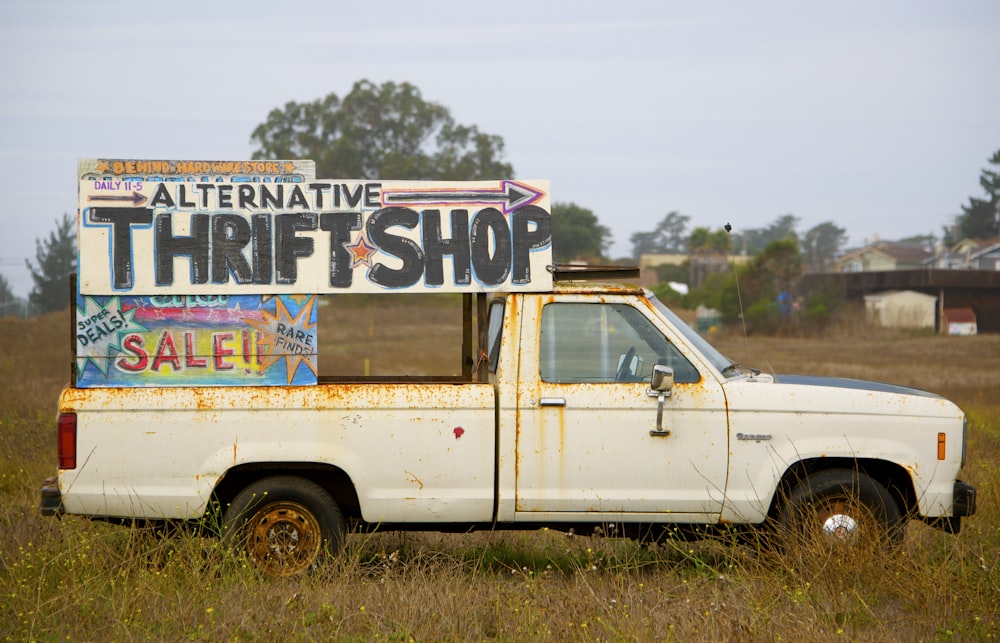 white single-cab truck with signage