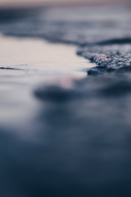 shallow focus photo of water wave in Tahunanui Beach New Zealand