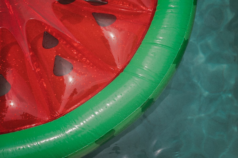 a slice of watermelon sitting on top of an inflatable raft