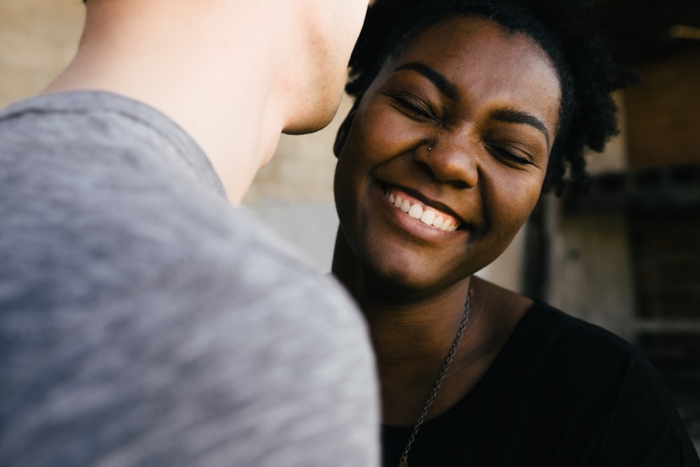 Man tells a joke as woman laughs in response