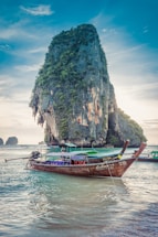 boats at the sea near stone island during day