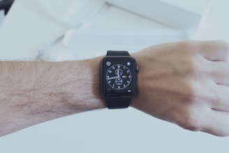 A close-up of a sleek smartwatch displaying notifications on a wrist.