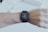 Close-up of a wrist wearing a sleek smartwatch with notifications visible on the screen.